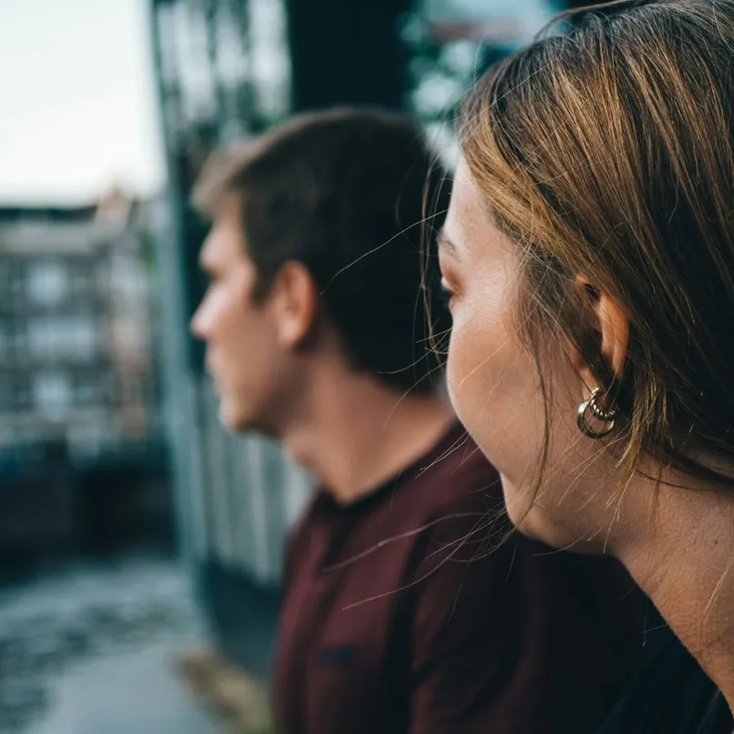 Teenagers looking out over a river